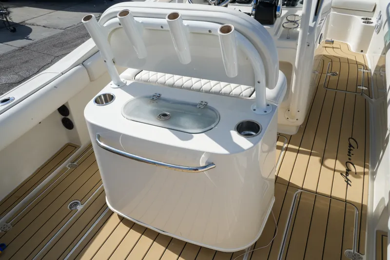 Slide: The Image of 2008 Chris-Craft Catalina 26 boat interior with fishing rod holders and teak flooring. - 10