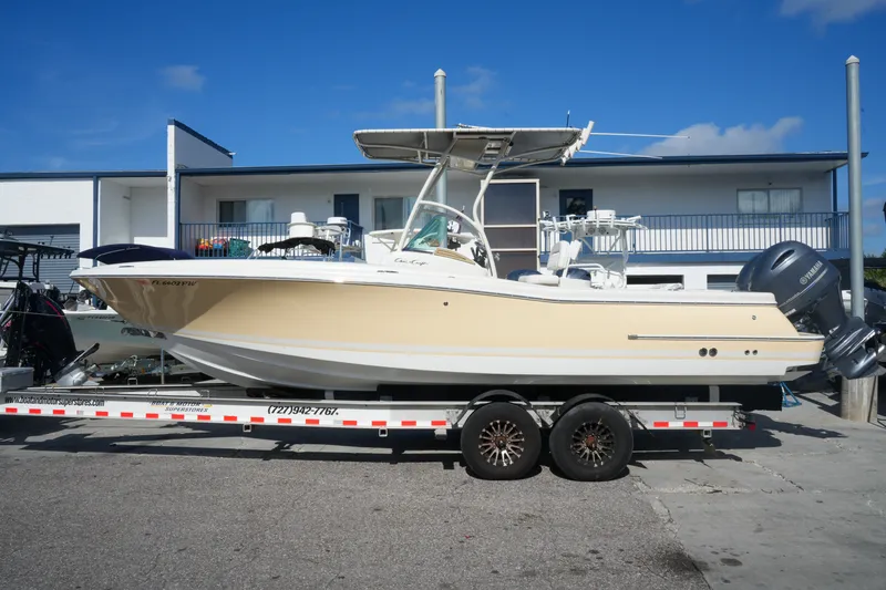 The Image of 2008 Chris-Craft Catalina 26 boat on trailer, parked outdoors under clear blue sky. - 1