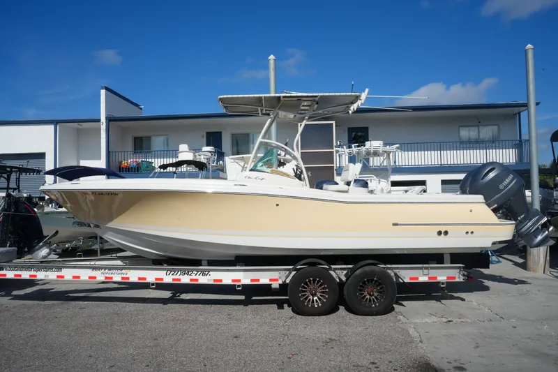 Slide: The Image of 2008 Chris-Craft Catalina 26 boat on trailer, parked outdoors under clear sky. - 2