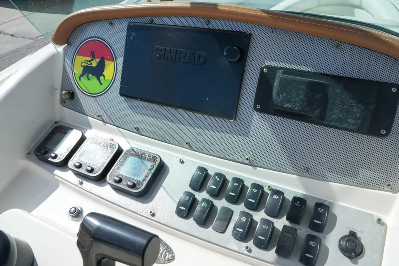Slide: The Image of Dashboard of a 2008 Chris-Craft Catalina 26 boat with control switches and navigation equipment. - 18