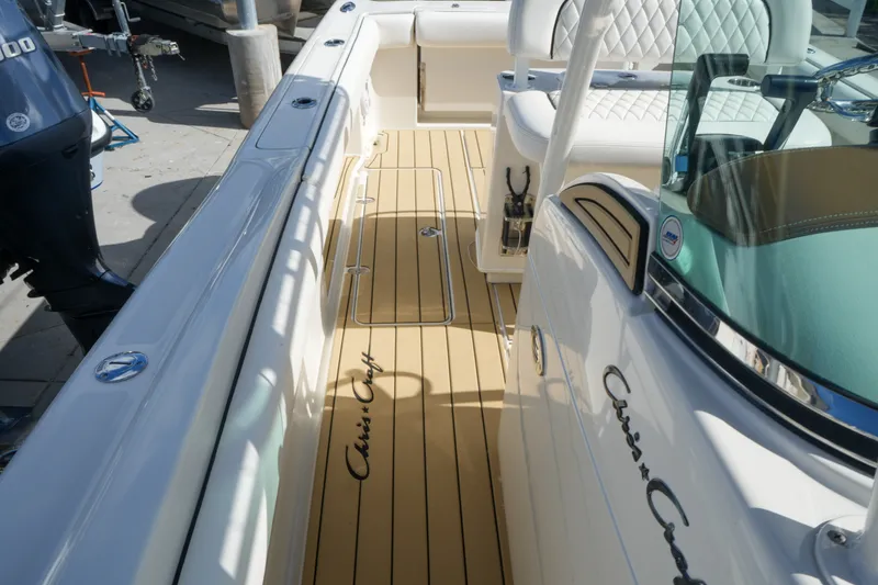 Slide: The Image of 2008 Chris-Craft Catalina 26 boat interior with teak flooring and luxurious seating. - 25