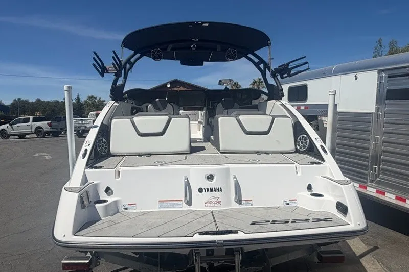 Slide: The Image of 2022 Yamaha Boats 252XE, rear view, showcasing spacious deck and sleek design. - 7