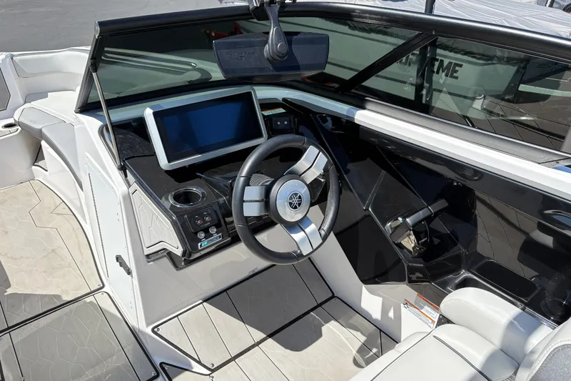 Slide: The Image of Interior view of 2022 Yamaha Boats 252XE, featuring modern dashboard and steering wheel. - 3