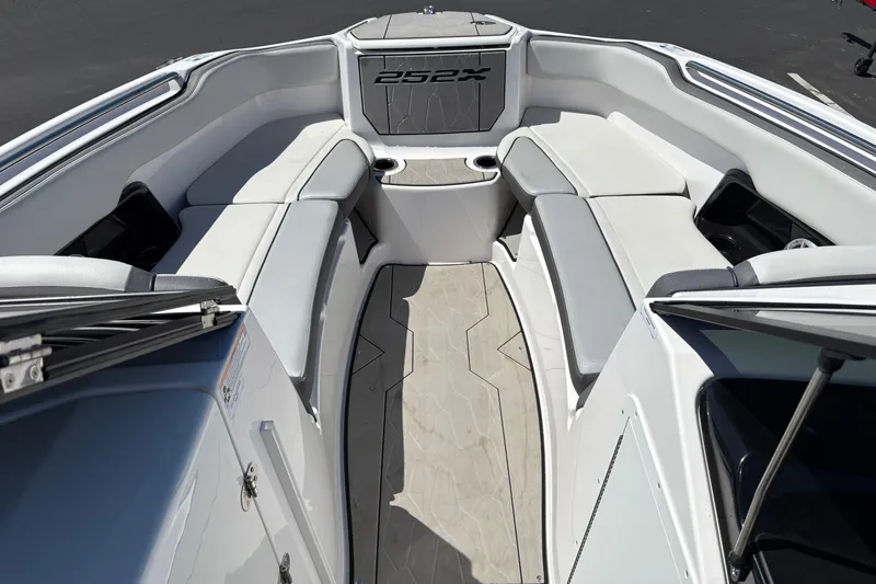 Slide: The Image of Interior view of 2022 Yamaha Boats 252XE, featuring spacious seating and modern design. - 2