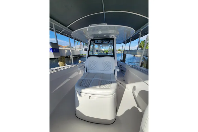 Slide: The Image of 2025 Sportsman Open 322 Center Console boat interior with cushioned seating and canopy. - 10