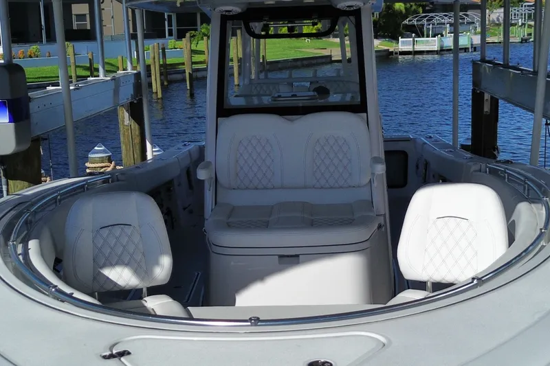 Slide: The Image of 2025 Sportsman Open 322 Center Console boat interior with luxurious seating and waterfront view. - 4