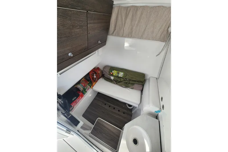 Slide: The Image of Interior cabin of 2025 Sportsman Open 322 Center Console boat with storage and seating. - 13