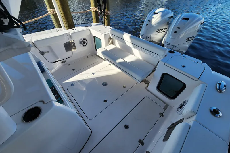 Slide: The Image of 2025 Sportsman Open 322 Center Console boat interior with seating and twin outboard engines. - 5