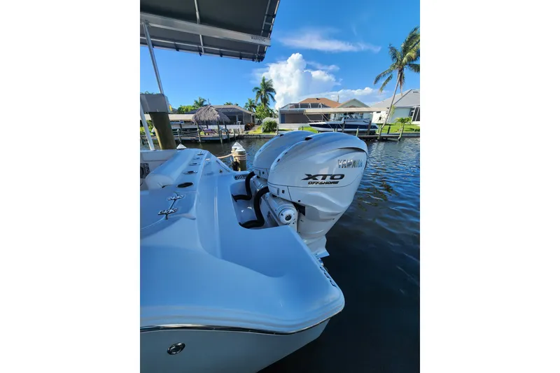 Slide: The Image of 2025 Sportsman Open 322 Center Console with Yamaha XTO engine docked by waterfront homes. - 6