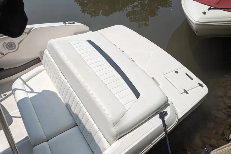 Slide: The Image of 2008 Regal 1900 LSR boat with white seating and swim platform, docked on calm water. - 12