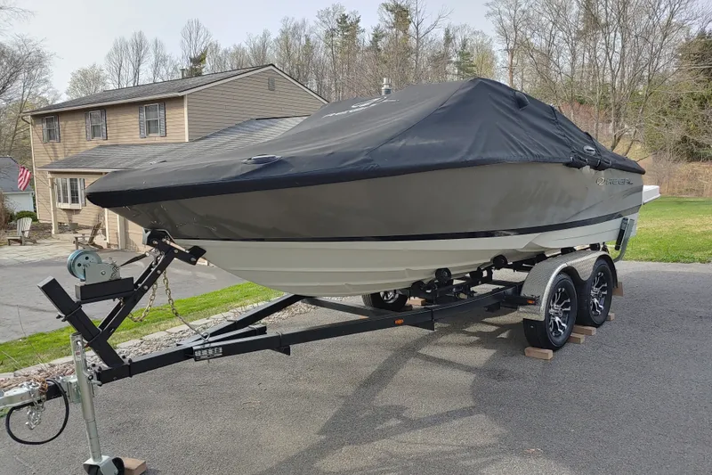 Slide: The Image of 2008 Regal 1900 LSR boat on trailer, covered, parked in driveway. - 17