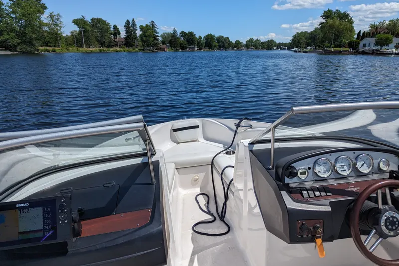 Slide: The Image of 2008 Regal 1900 LSR boat dashboard with scenic lake view in the background. - 13