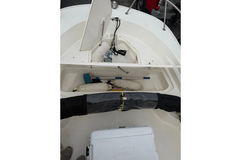Slide: The Image of 2021 Boston Whaler 190 Montauk boat interior with storage compartments and equipment. - 10