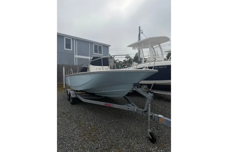 Slide: The Image of 2021 Boston Whaler 190 Montauk boat on trailer, parked outdoors. - 3