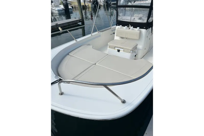Slide: The Image of 2021 Boston Whaler 190 Montauk boat interior with cushioned seating and console. - 9