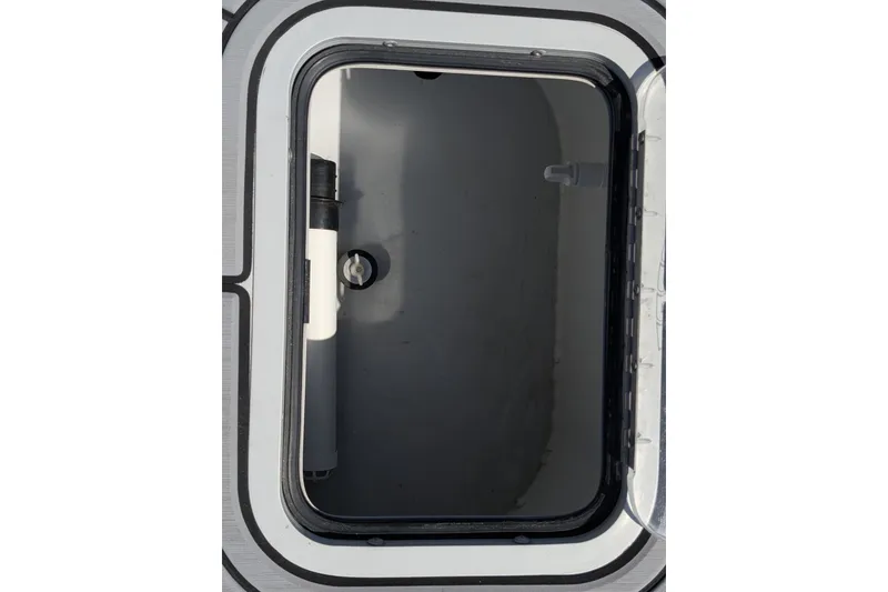 Slide: The Image of Open hatch on 2022 Encore Boat Works 28, showcasing interior compartment. - 13