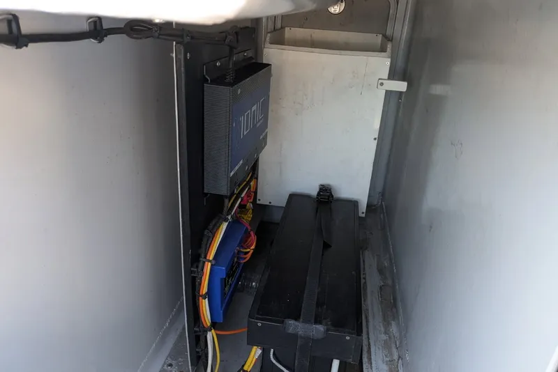 Slide: The Image of Interior view of 2022 Encore Boat Works 28, showcasing electrical components and wiring. - 20