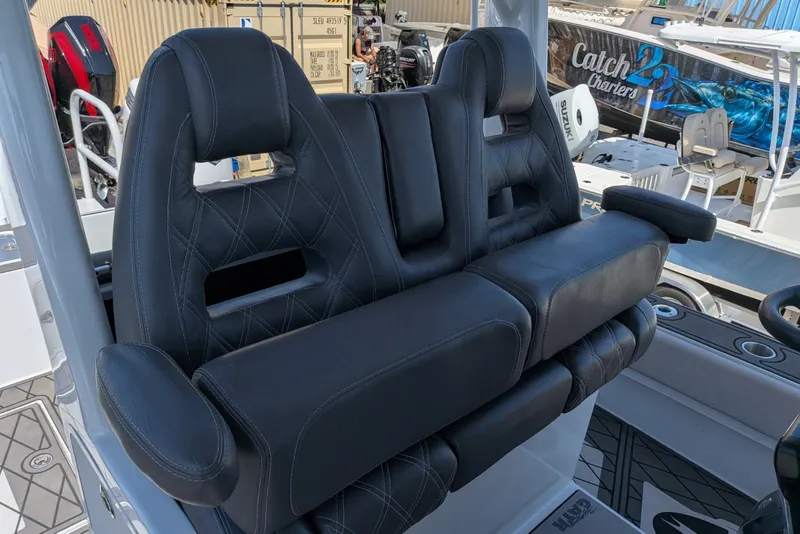 Slide: The Image of Luxurious seating on 2022 Encore Boat Works 28, featuring black leather upholstery. - 9