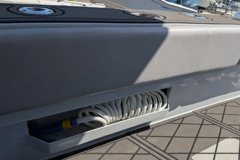 Slide: The Image of Coiled hose storage on 2022 Encore Boat Works 28 deck. - 17