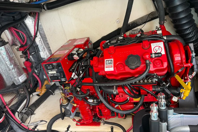 Slide: The Image of Engine compartment of a 2019 Regal 33 XO boat, featuring a red EFI engine. - 34