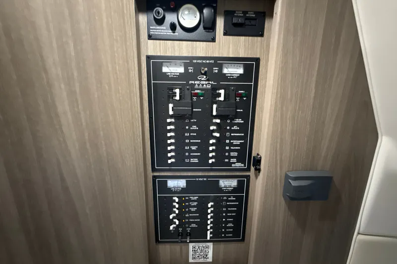 Slide: The Image of Electrical control panel on a 2019 Regal 33 XO boat, featuring switches and gauges. - 30
