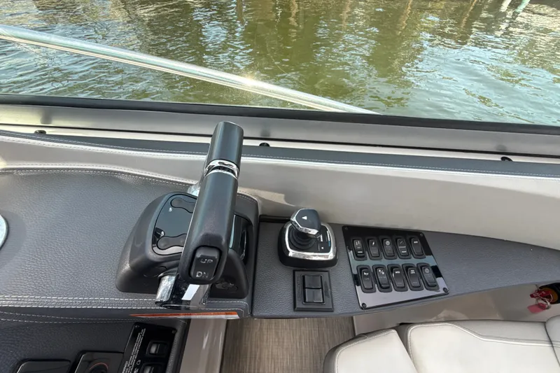 Slide: The Image of Control panel of a 2019 Regal 33 XO boat with throttle and switches. - 18
