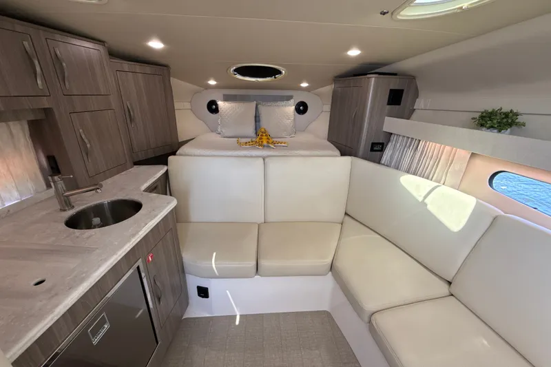 Slide: The Image of Luxurious interior of 2019 Regal 33 XO yacht with modern kitchen and cozy seating. - 20