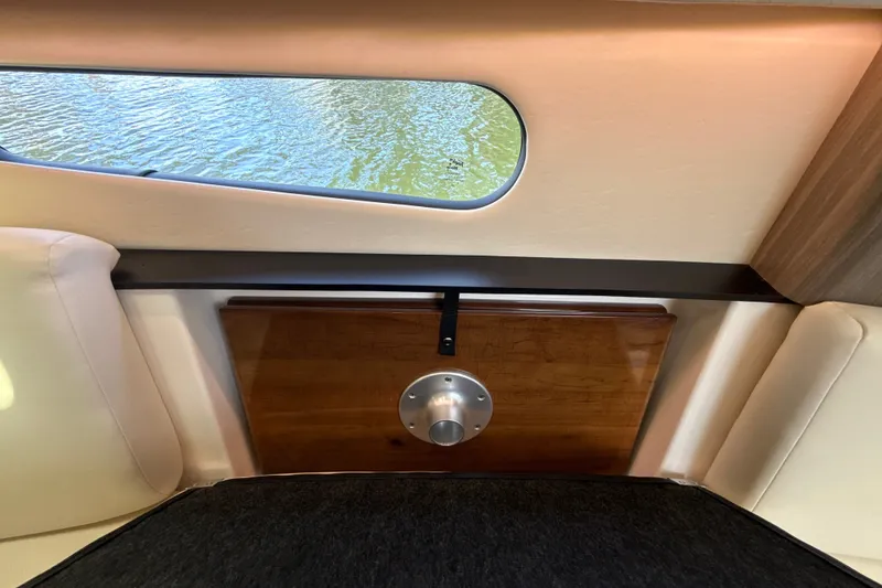 Slide: The Image of Interior view of 2019 Regal 33 XO yacht with window and wooden panel. - 26