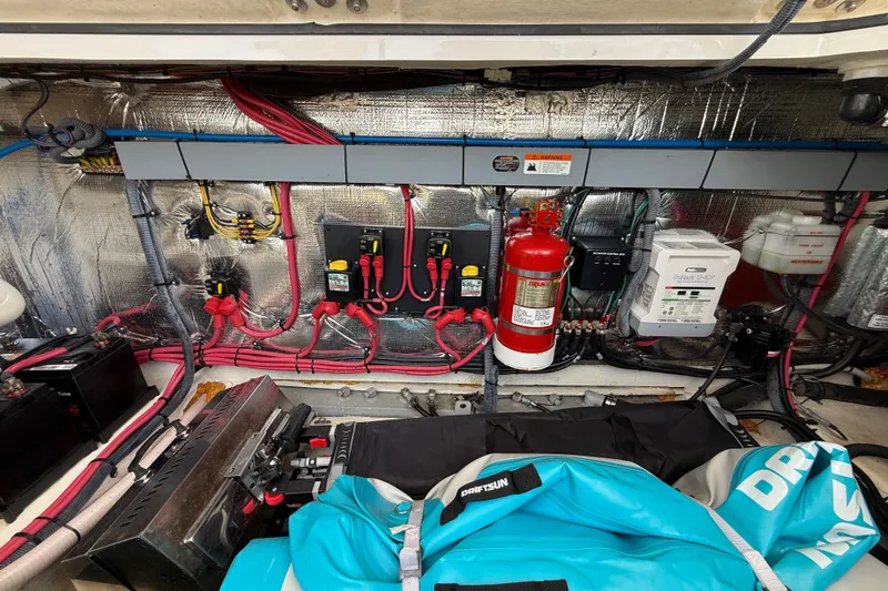 Slide: The Image of Engine compartment of a 2019 Regal 33 XO boat with wiring and fire extinguisher. - 35