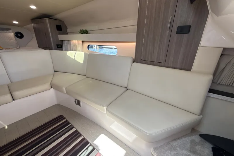 Slide: The Image of Interior of 2019 Regal 33 XO yacht with white seating and wooden cabinetry. - 25