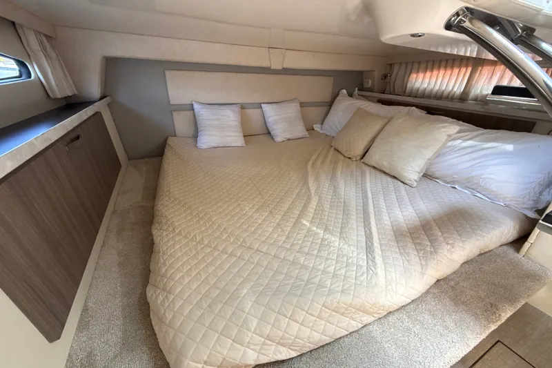 Slide: The Image of Luxurious cabin interior of 2019 Regal 33 XO yacht with cozy bedding and elegant decor. - 28