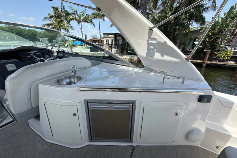 Slide: The Image of 2019 Regal 33 XO yacht interior with sink, counter, and storage cabinets. - 10