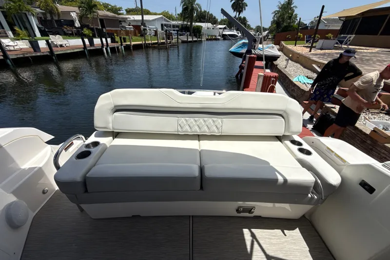 Slide: The Image of 2019 Regal 33 XO boat interior with white seating by a canal. - 7