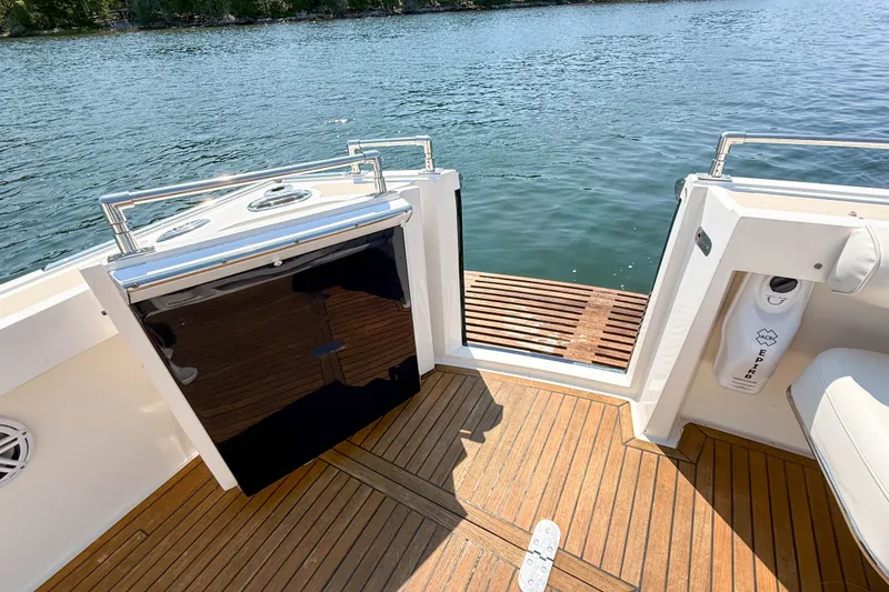 Slide: The Image of 2008 Grand Banks 45 Eastbay SX yacht deck with teak flooring and water view. - 46