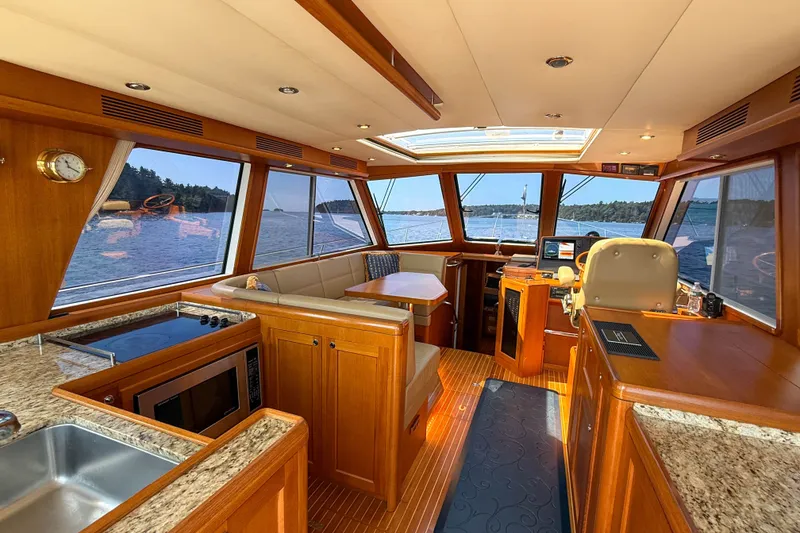 Slide: The Image of Luxurious interior of 2008 Grand Banks 45 Eastbay SX yacht with panoramic windows and elegant wood finish. - 14