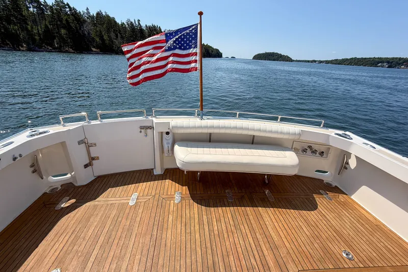 Slide: The Image of 2008 Grand Banks 45 Eastbay SX yacht deck with American flag, scenic water view. - 45
