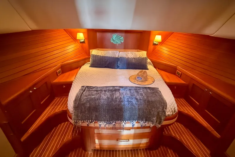 Slide: The Image of Luxurious cabin interior of 2008 Grand Banks 45 Eastbay SX yacht with cozy bed and warm lighting. - 31