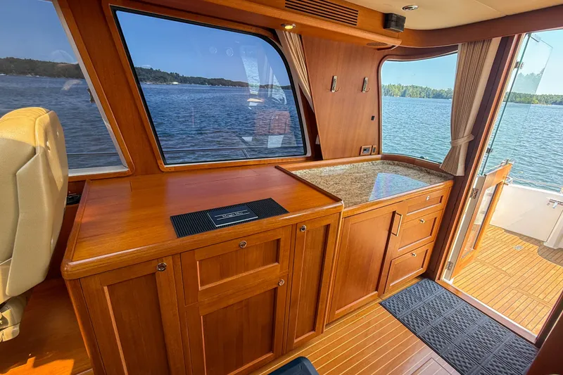 Slide: The Image of Interior of 2008 Grand Banks 45 Eastbay SX yacht with wooden cabinetry and scenic water view. - 21