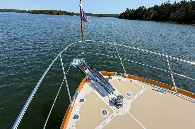 Slide: The Image of Bow view of 2008 Grand Banks 45 Eastbay SX yacht on calm waters. - 49