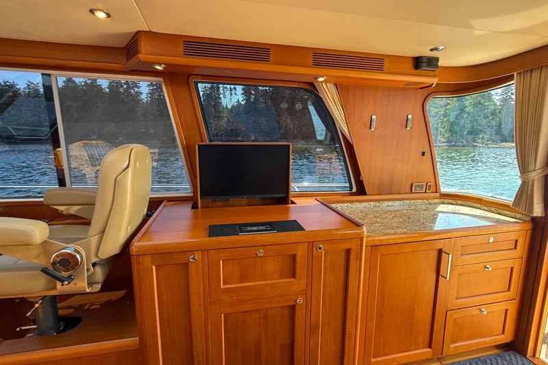 Slide: The Image of Luxurious interior of 2008 Grand Banks 45 Eastbay SX yacht with wood cabinetry and scenic windows. - 22