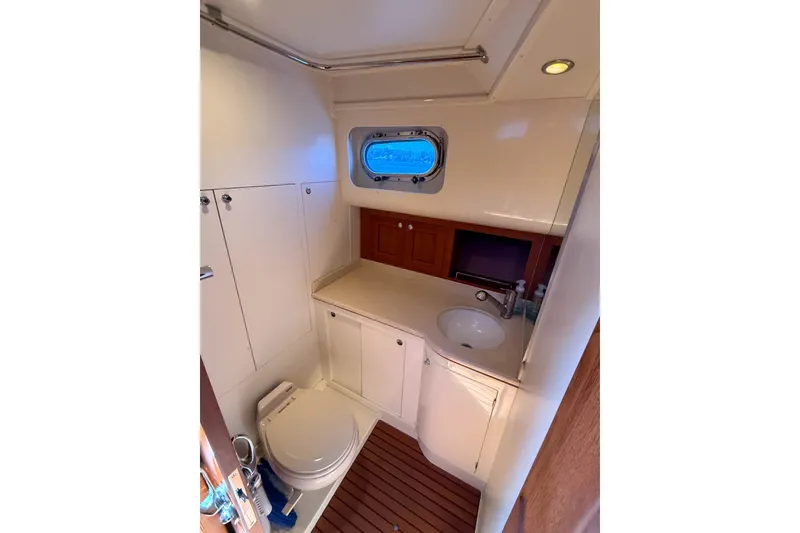 Slide: The Image of Luxurious bathroom in 2008 Grand Banks 45 Eastbay SX yacht with sink and porthole. - 43