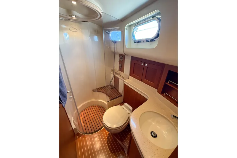Slide: The Image of Luxurious 2008 Grand Banks 45 Eastbay SX yacht bathroom with shower and wooden accents. - 36