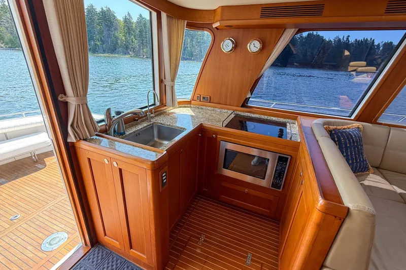 Slide: The Image of Luxurious 2008 Grand Banks 45 Eastbay SX yacht interior with kitchen and scenic water view. - 17