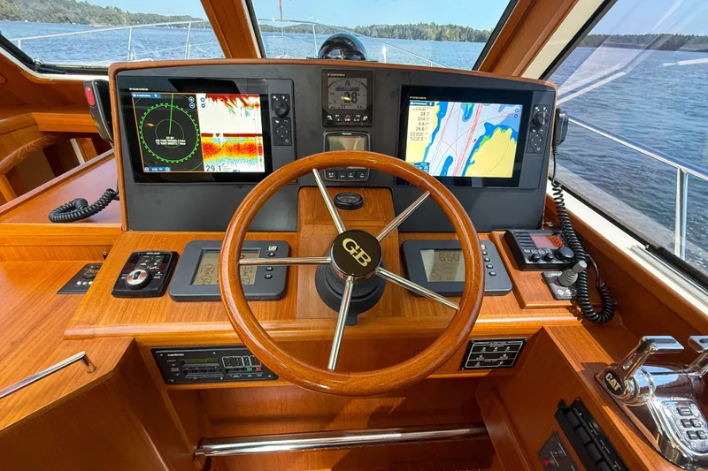 Slide: The Image of Helm of 2008 Grand Banks 45 Eastbay SX with navigation screens and wooden steering wheel. - 27