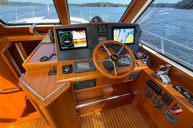 Slide: The Image of 2008 Grand Banks 45 Eastbay SX helm with navigation screens and wooden steering wheel. - 26