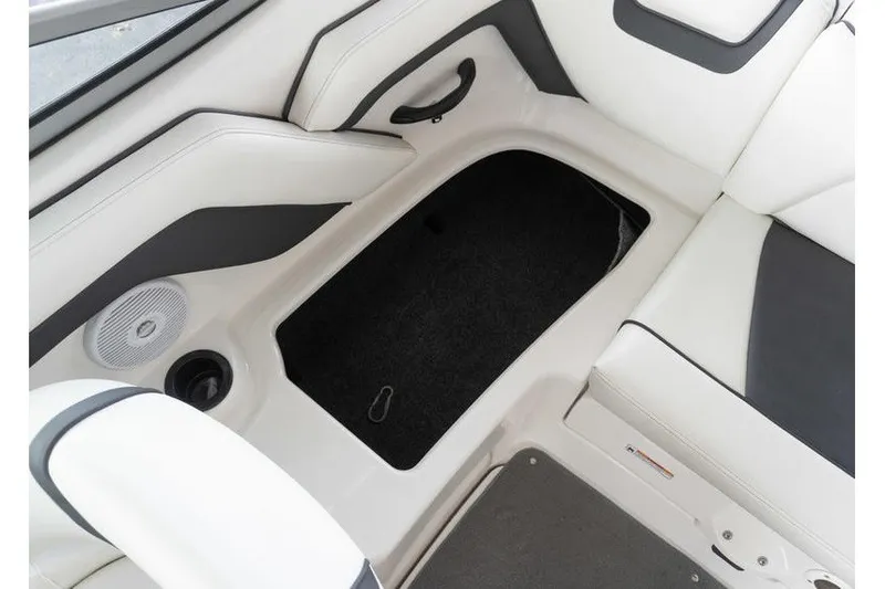 Slide: The Image of Interior storage compartment of a 2015 Yamaha Boats AR190, featuring sleek white and black seating. - 18