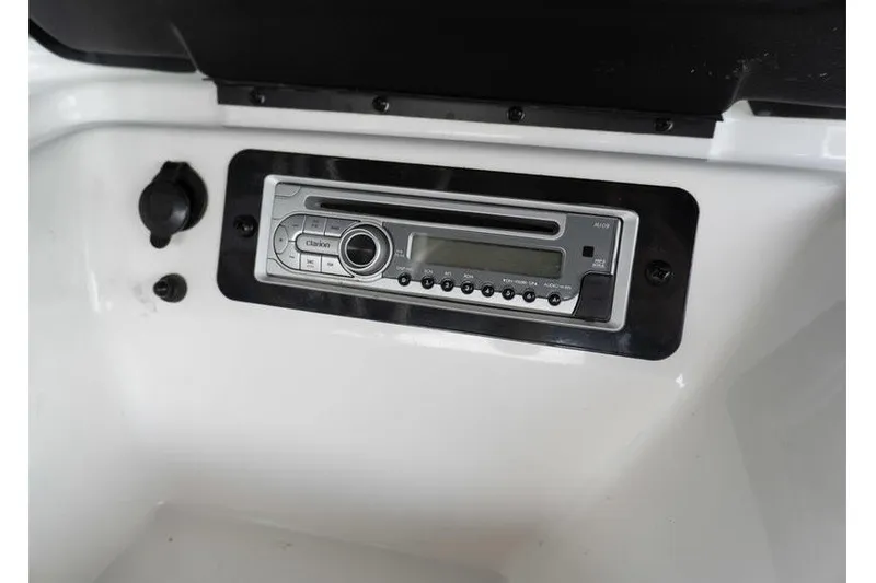 Slide: The Image of 2015 Yamaha Boats AR190 stereo system on white dashboard. - 10