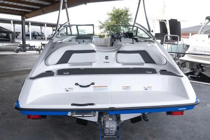 Slide: The Image of 2015 Yamaha Boats AR190, rear view in a covered marina setting. - 3