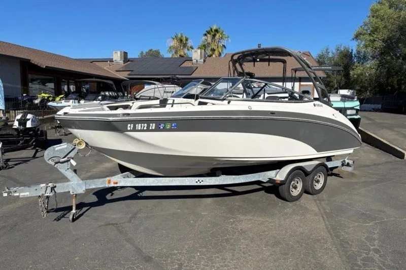 Slide: The Image of 2015 Yamaha Boats AR240 HO on trailer, parked outdoors under clear blue sky. - 0