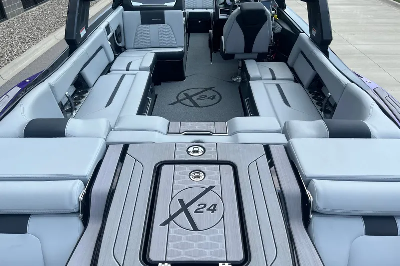 Slide: The Image of 2023 MasterCraft X24 boat interior with luxurious seating and modern design. - 9